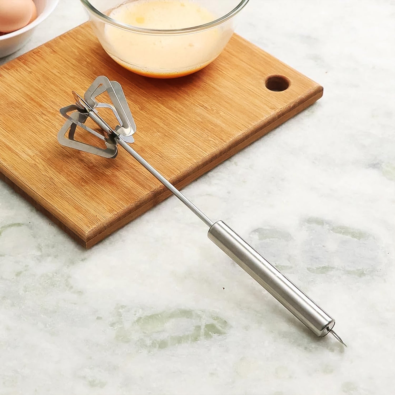 Ergonomic stainless steel manual whisk for effortless blending.