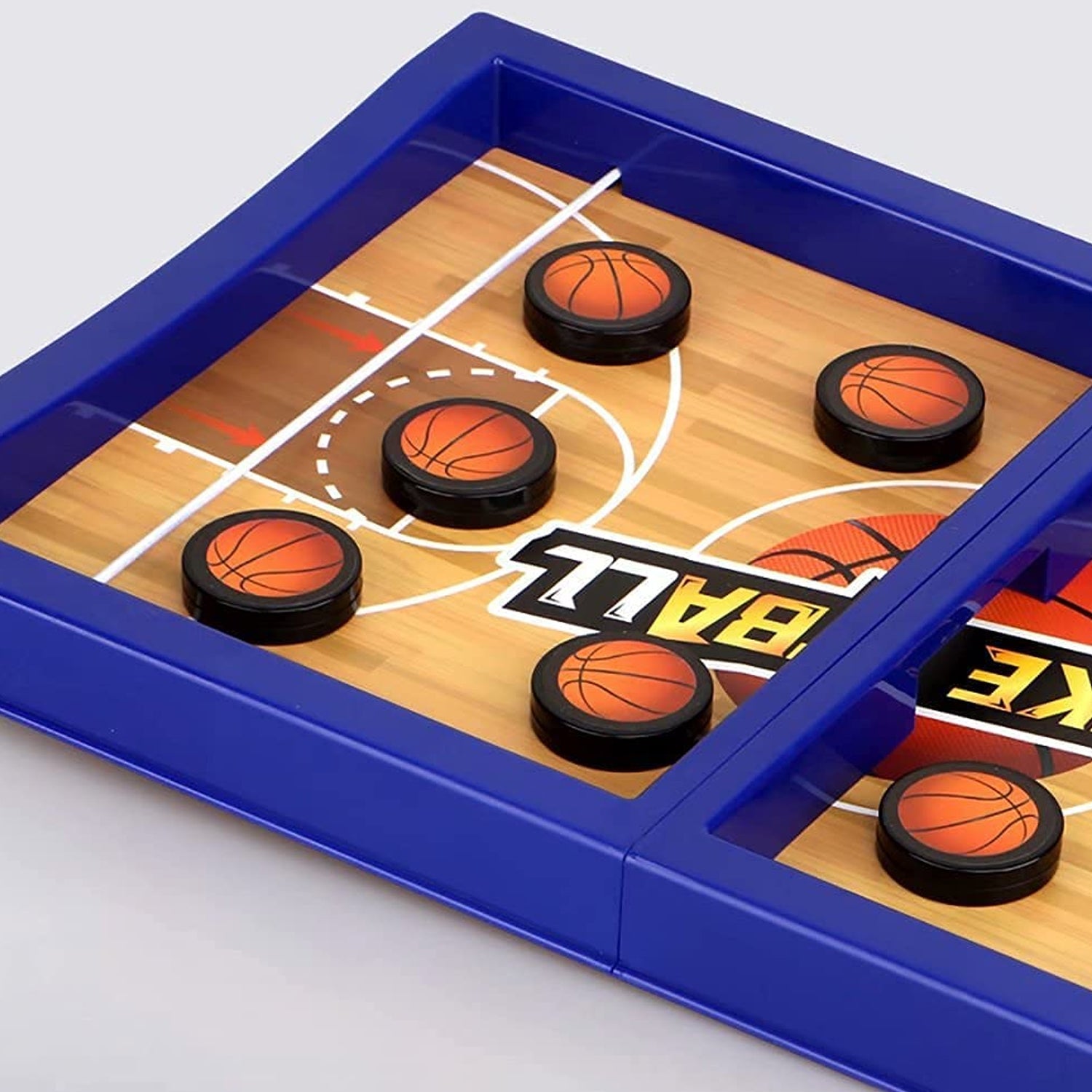 Hands of children playing the interactive desktop basketball game, aiming pucks.
