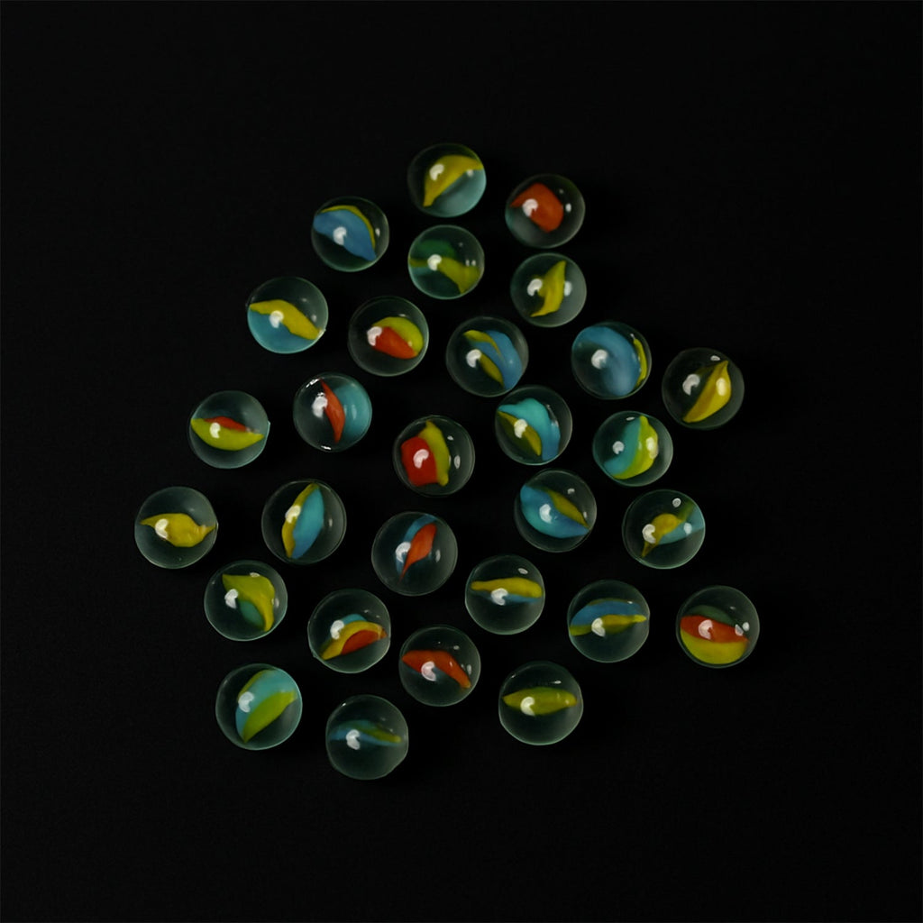 Glass marbles displayed with colorful swirl designs, ideal for kids and crafts