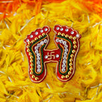 Detailed view of divine footprints sticker with multicolored beads and stones