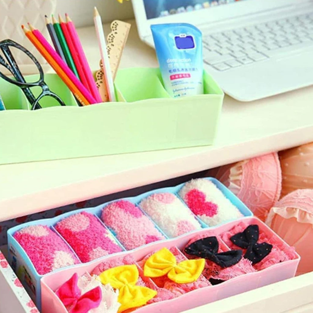 A 5-grid drawer organizer box perfectly fitted inside a drawer, keeping clothes tidy and accessible.