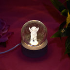 A hand holding the Moon Crystal Ball Lamp, demonstrating its compact size and portability.