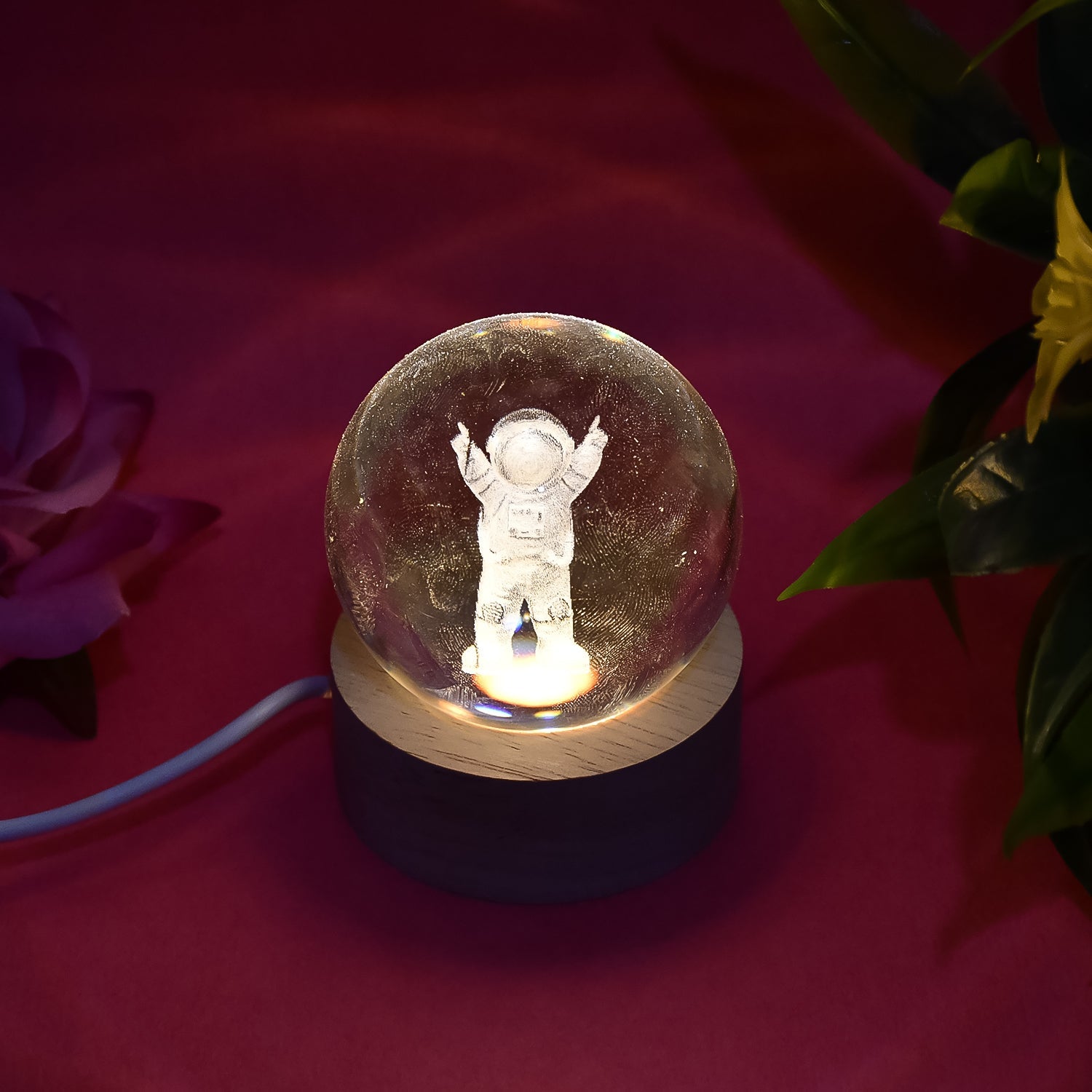 A hand holding the Moon Crystal Ball Lamp, demonstrating its compact size and portability.