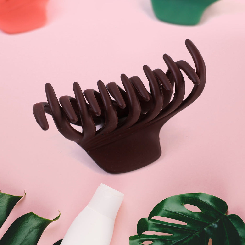 Close-up of matte plastic hair clamp on white background