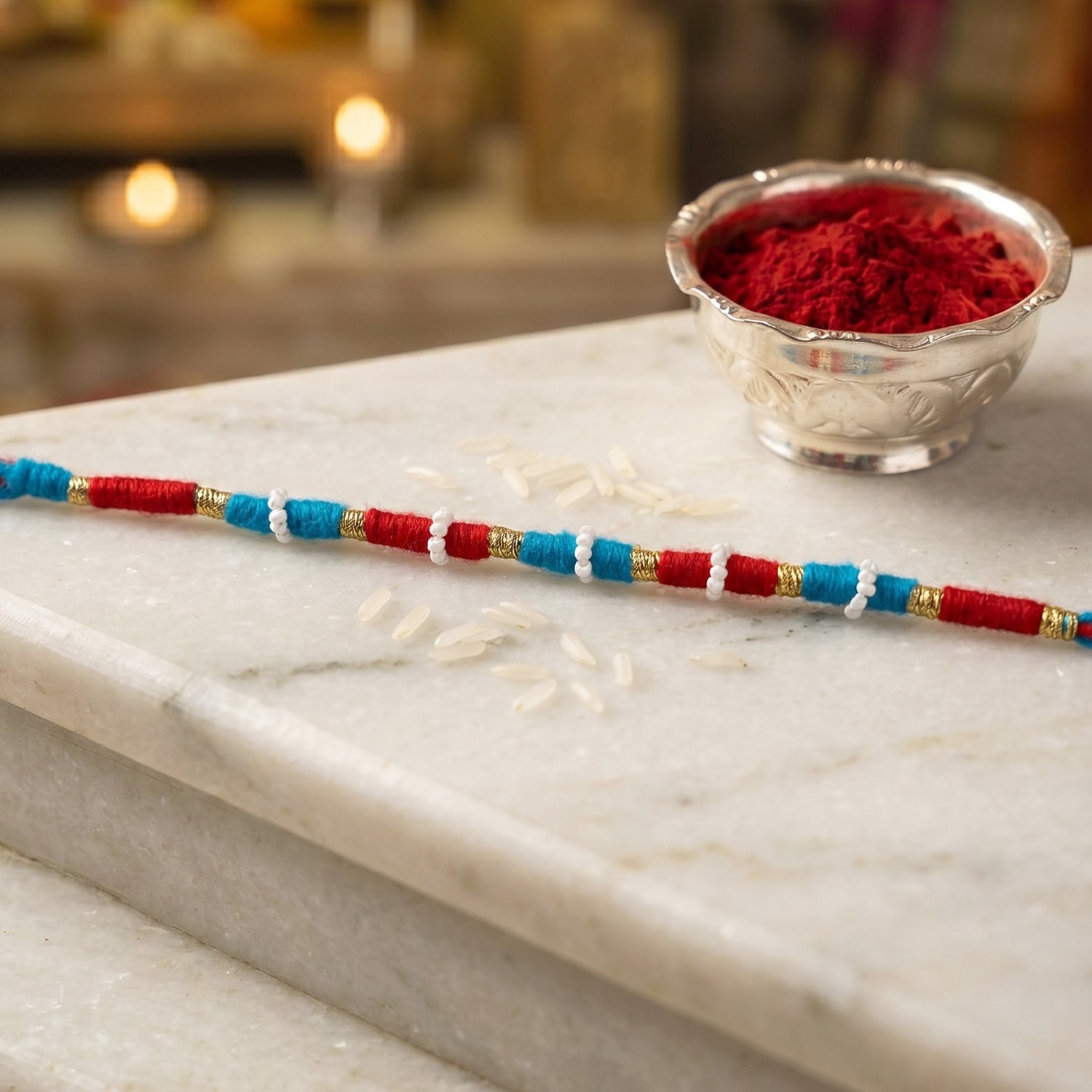 Decorative red rakhi thread bracelet with gold accents