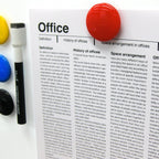 Three translucent yellow circular magnetic buttons arranged