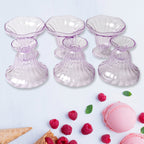 Clear plastic serving bowls displayed with various fruits and snacks.