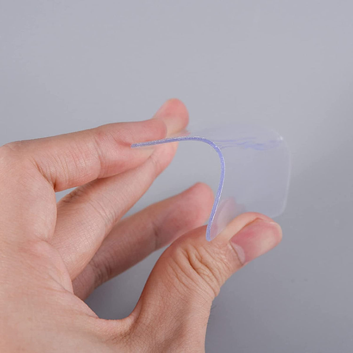 Clear double-sided nano adhesive tape on a roll for multi-surface applications.
