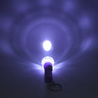 Mini LED keychain torch showing push-button switch and plastic body