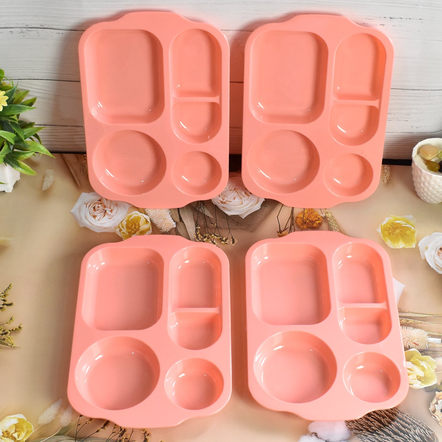 Top-down view of vibrant, multicolor 5-compartment food plates.