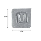 Multiple self-adhesive transparent hooks neatly organized on a surface.