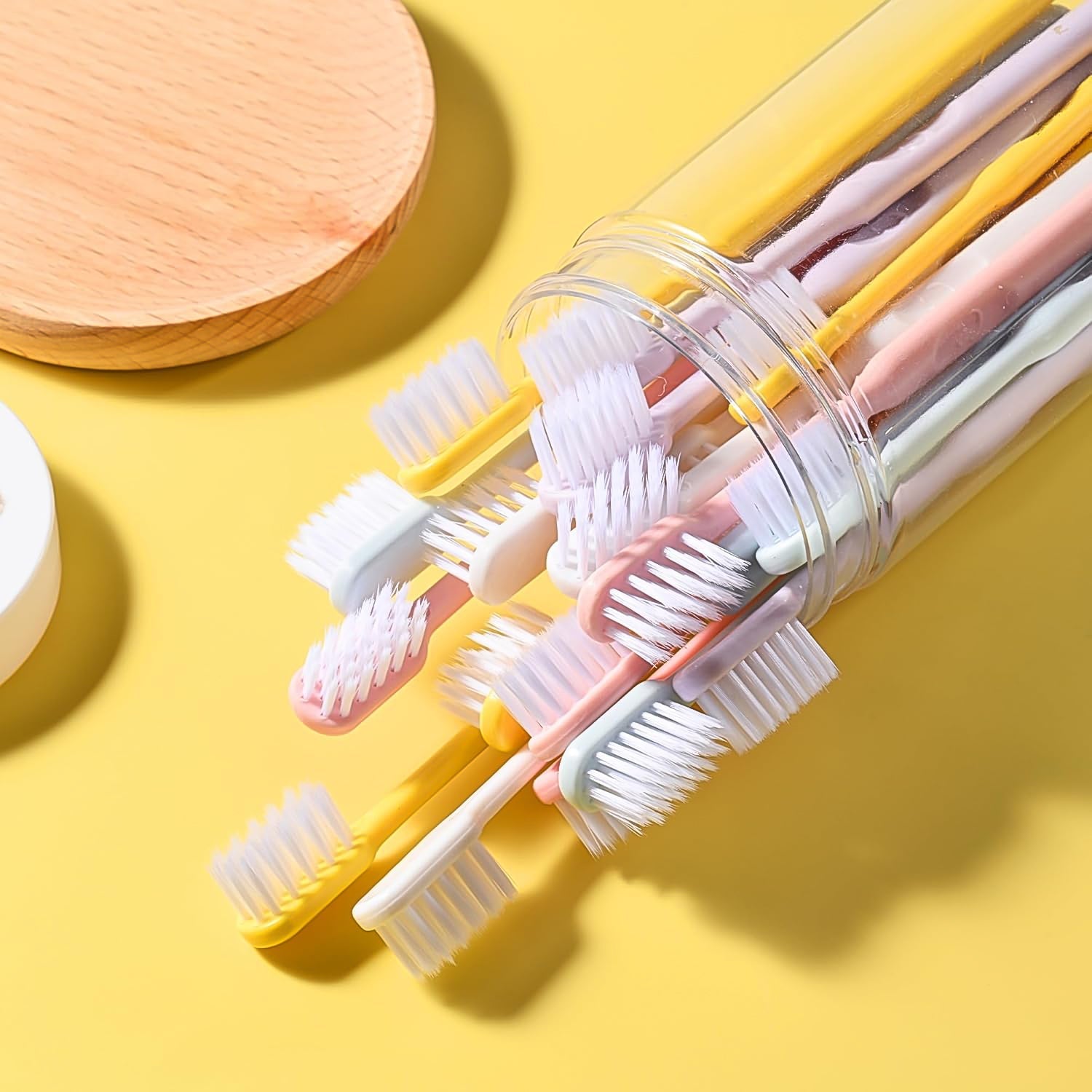 Single soft plastic toothbrush held, demonstrating its comfortable grip and flexible design.