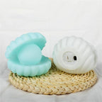 A detailed view of the Pearl Shell Night Lamp's textured surface and illuminated pearl.