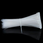 Black nylon cable ties securely holding a group of electrical wires together.