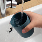 Family bathroom organizer with two cups and multiple toothbrush slots, ideal for space-saving solutions.