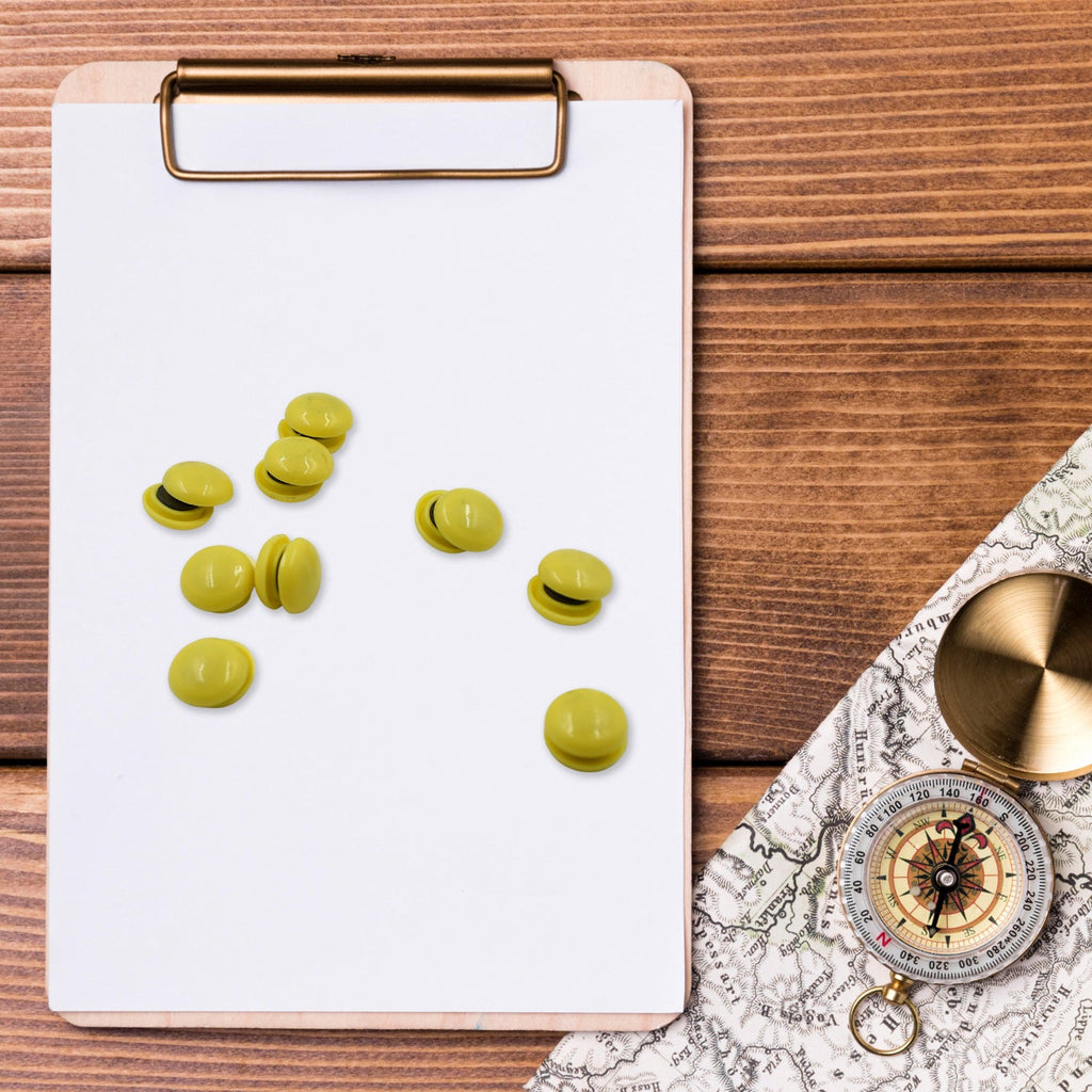 Strong plastic magnetic pins securely holding documents on a magnetic board.