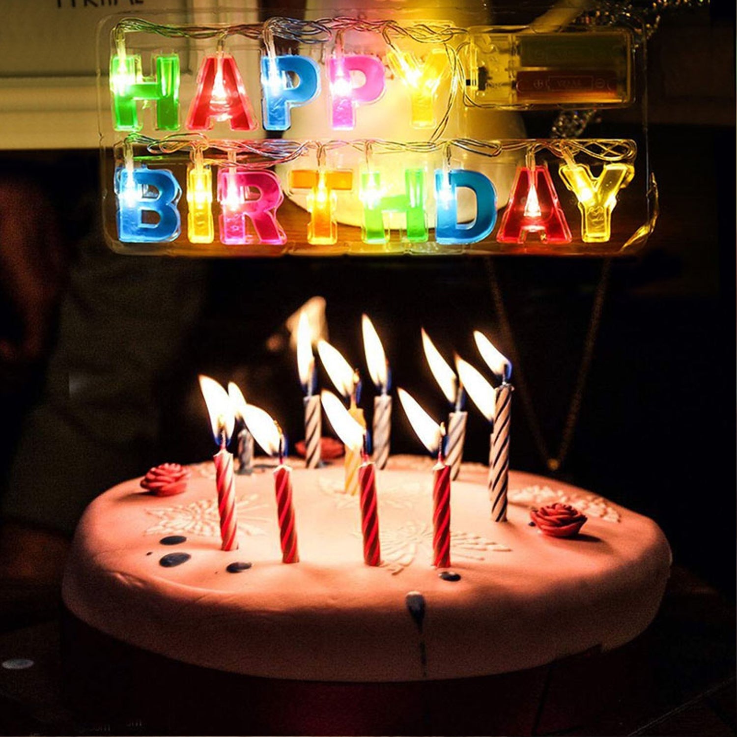 Close-up of multicolour Happy Birthday LED letter string lights in plastic holder