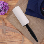 Lint roller with refill rolls displayed on a white background