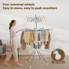Clothes drying rack in use with multiple hanging garments drying