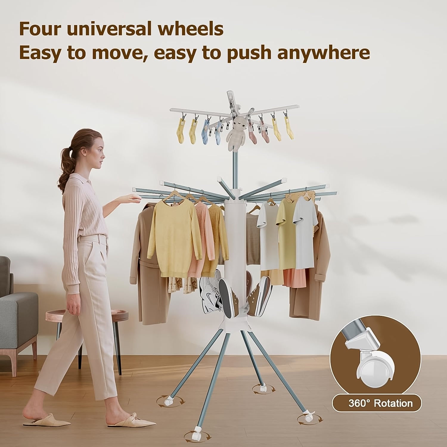 Clothes drying rack in use with multiple hanging garments drying