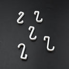 Multi-angle view of the strong self-adhesive plastic hook, highlighting its sleek design.
