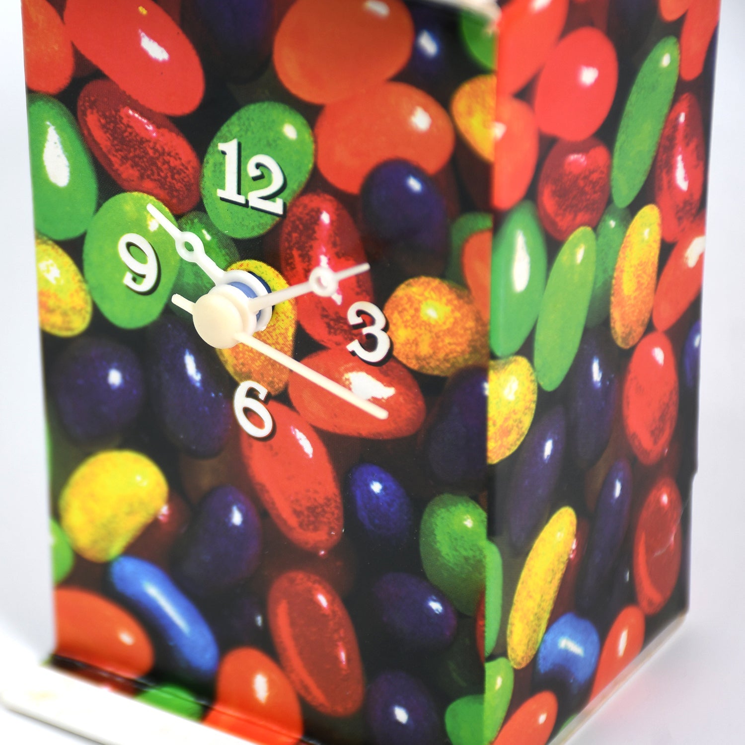Portable Deskrova table clock held in hand, demonstrating its compact size and lightweight design.