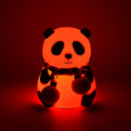 Rechargeable panda LED lamp on a bedside table, providing a gentle glow.