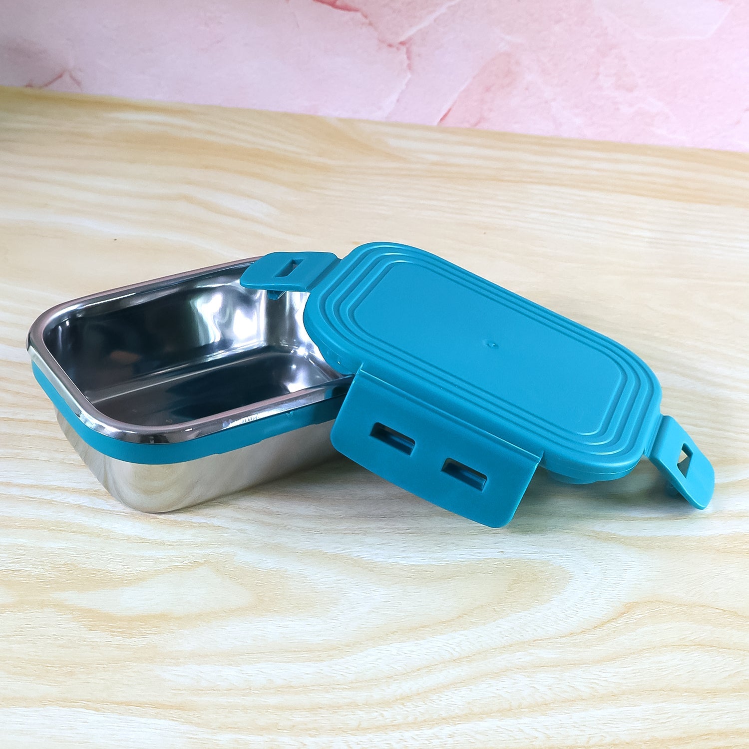 Top view showing teal leak-proof silicone lid on stainless steel mini container