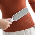 Hand holding the reusable lint brush, demonstrating its easy grip.