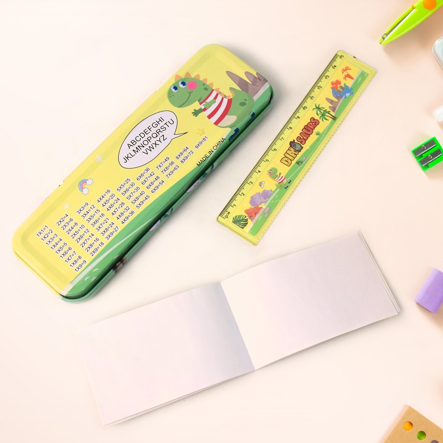 Open dinosaur pencil box revealing colorful pencils inside