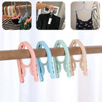 Space-saving foldable travel hanger designed to keep clothes wrinkle-free