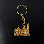 Close-up of golden Ram Mandir keychain with detailed architectural carvings