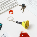 Red metal 'Ring for Wine' bell keychain with black handle