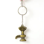 Close-up of Lord Shiva Shivaling metal keychain with detailed serpent design