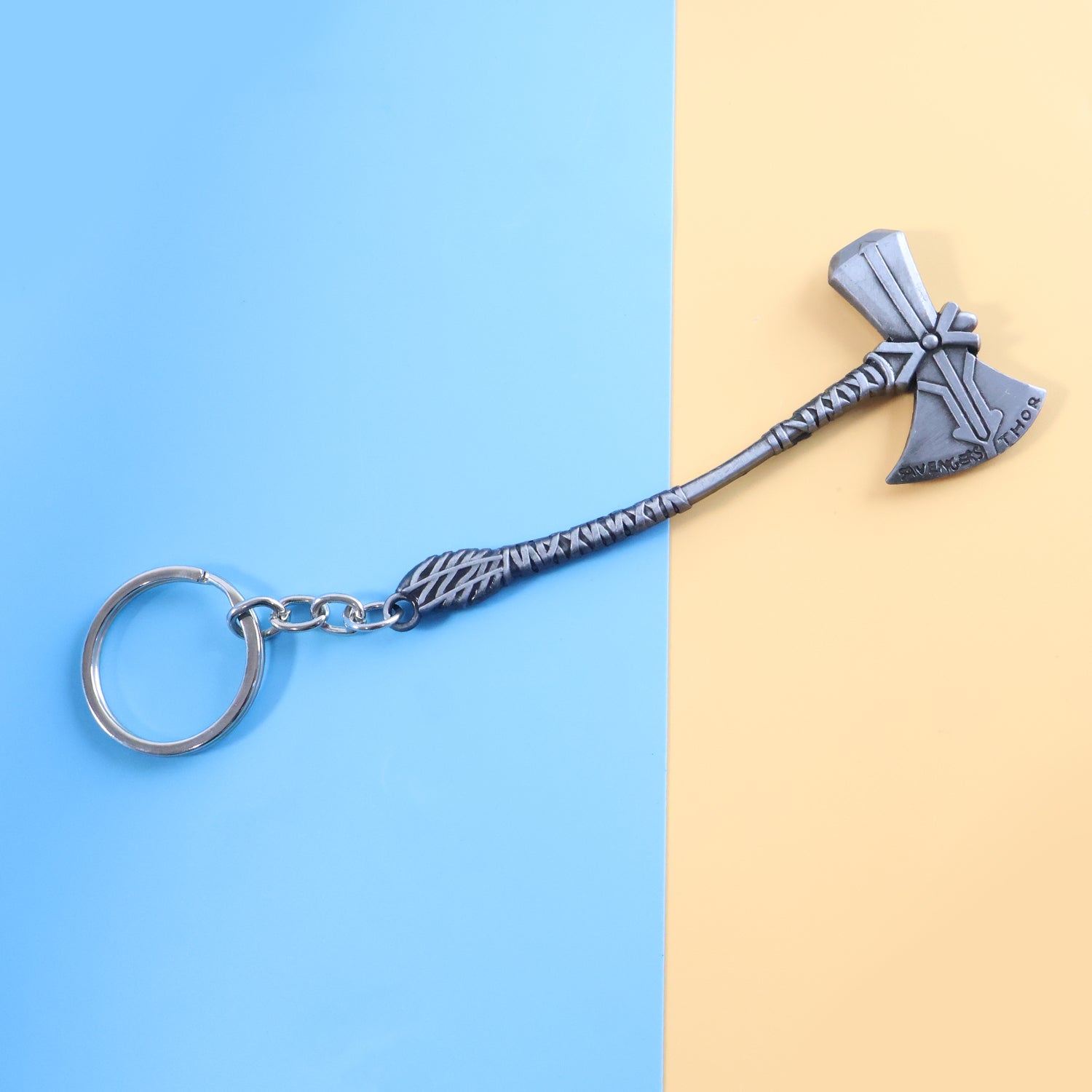 Close-up view of stylish metal axe keychain accessory with matte finish