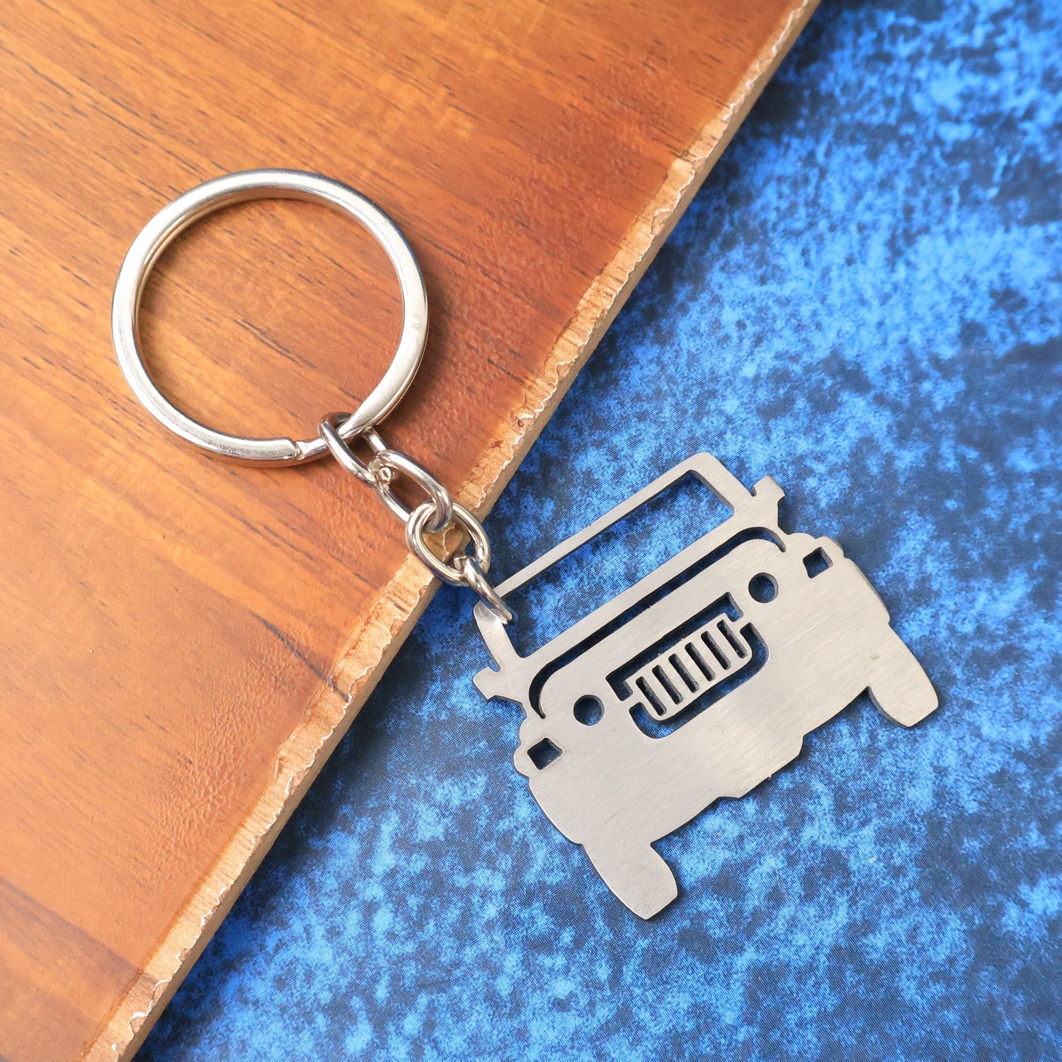 Side view of metal jeep keychain showing compact design