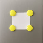 Arrangement of several white round magnetic buttons, ready for versatile use.