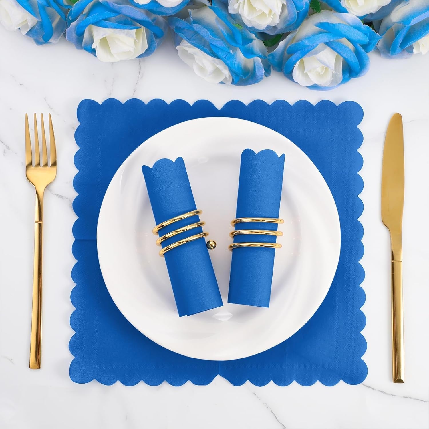 Two royal blue scalloped napkins, one open, showcasing size and texture