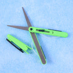 Detail of the retractable handle mechanism on the portable pen scissors.