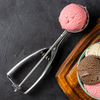 Side view of stainless steel ice cream scoop for cookie dough portioning