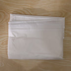 Folded suit cover, space-efficient for travel and storage.