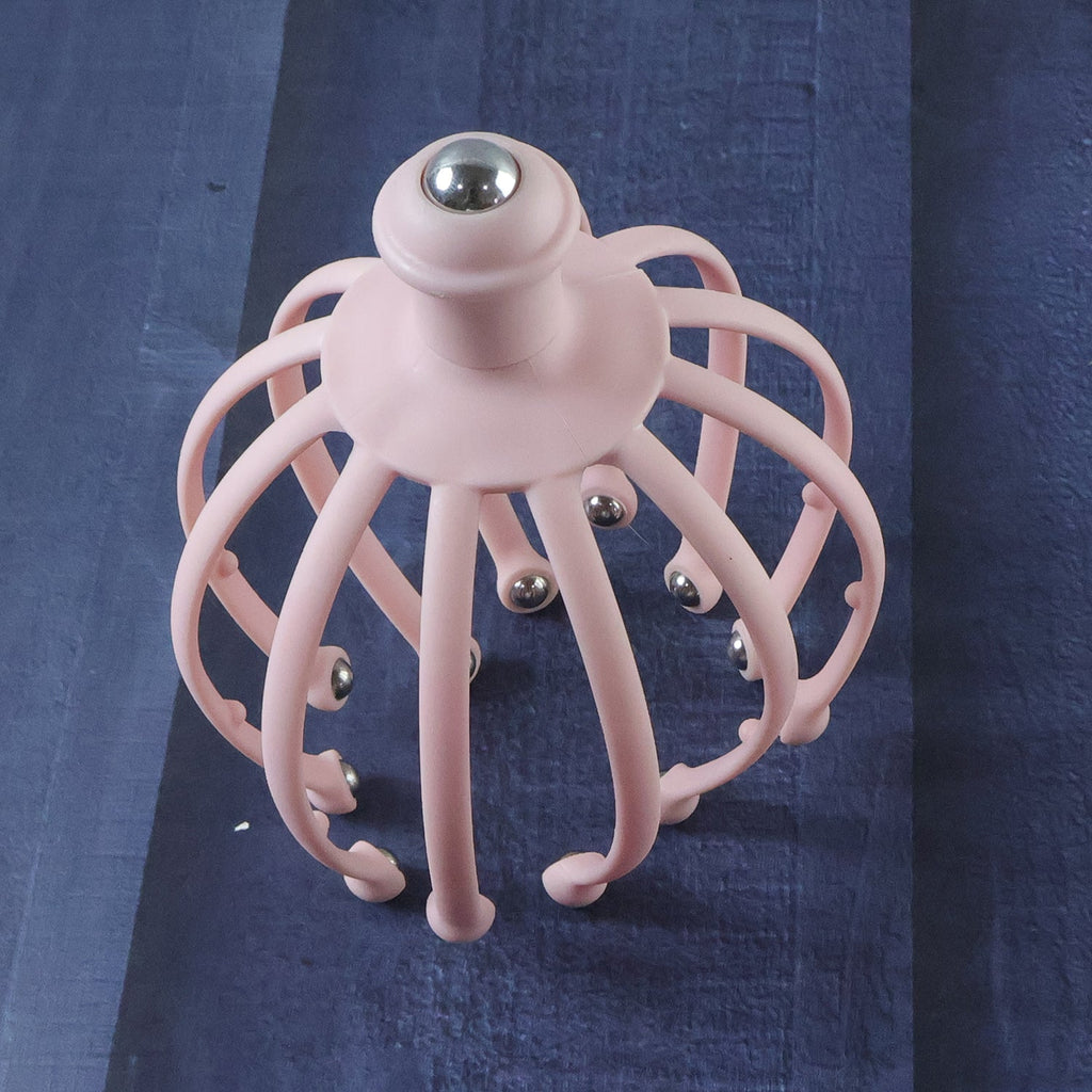 Hand holding a scalp massager, demonstrating its use for stress relief.