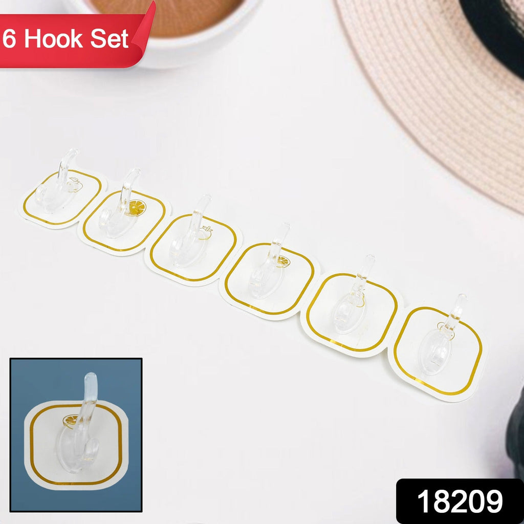 Transparent adhesive hooks holding kitchen utensils and bathroom towels, showcasing versatile use.