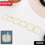 Transparent adhesive hooks holding kitchen utensils and bathroom towels, showcasing versatile use.