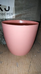 Round plastic planter in a modern indoor setting, demonstrating its versatility.