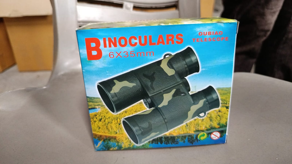 A child looking through Learning Toy Binoculars, engaging with nature.