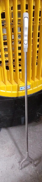 The garbage picker tool shown in use, making rubbish pickup effortless.