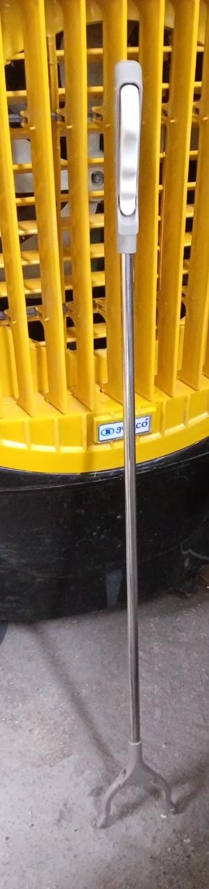 The garbage picker tool shown in use, making rubbish pickup effortless.