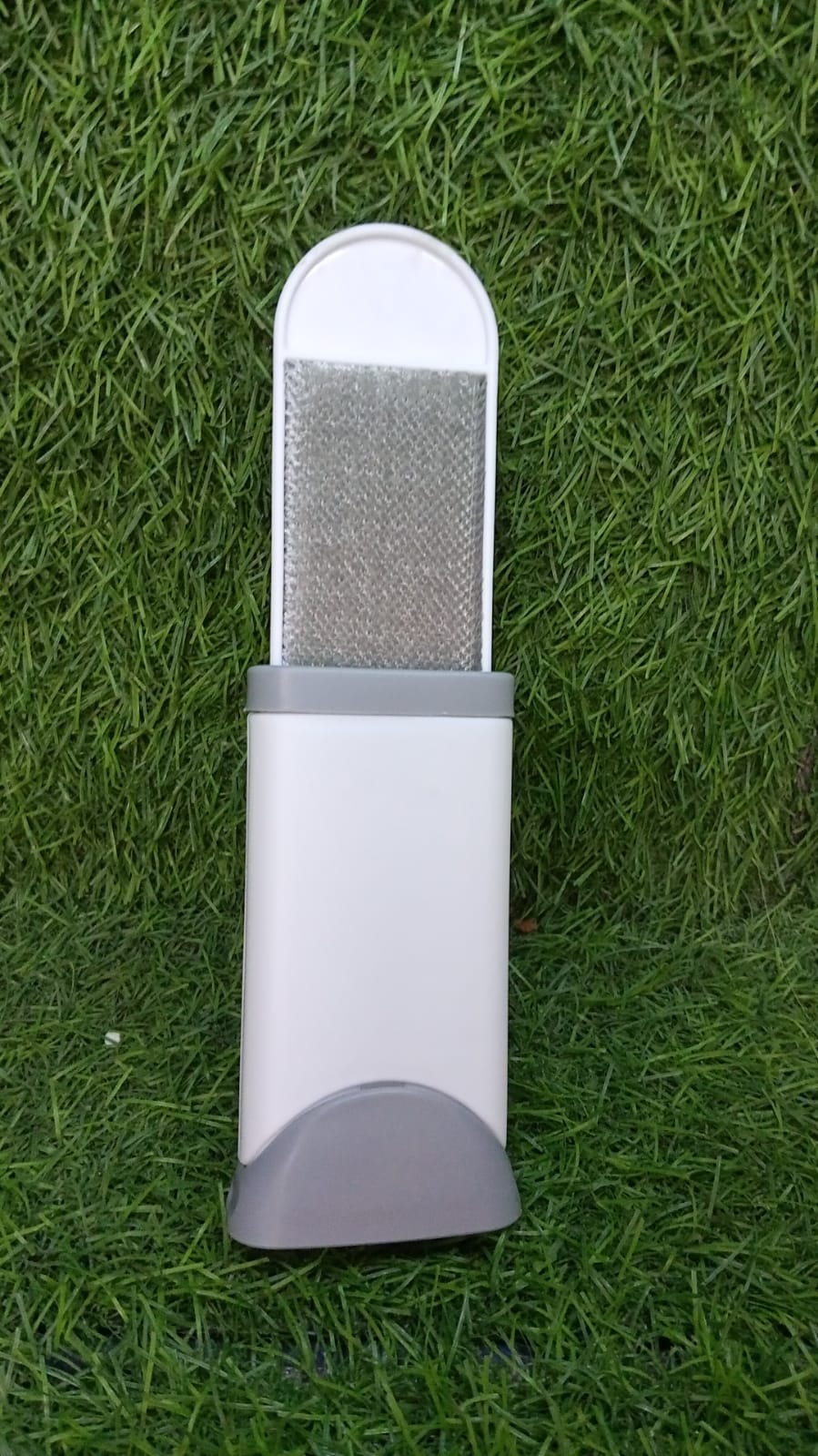 Close-up of the double-sided lint remover brush texture on fabric.