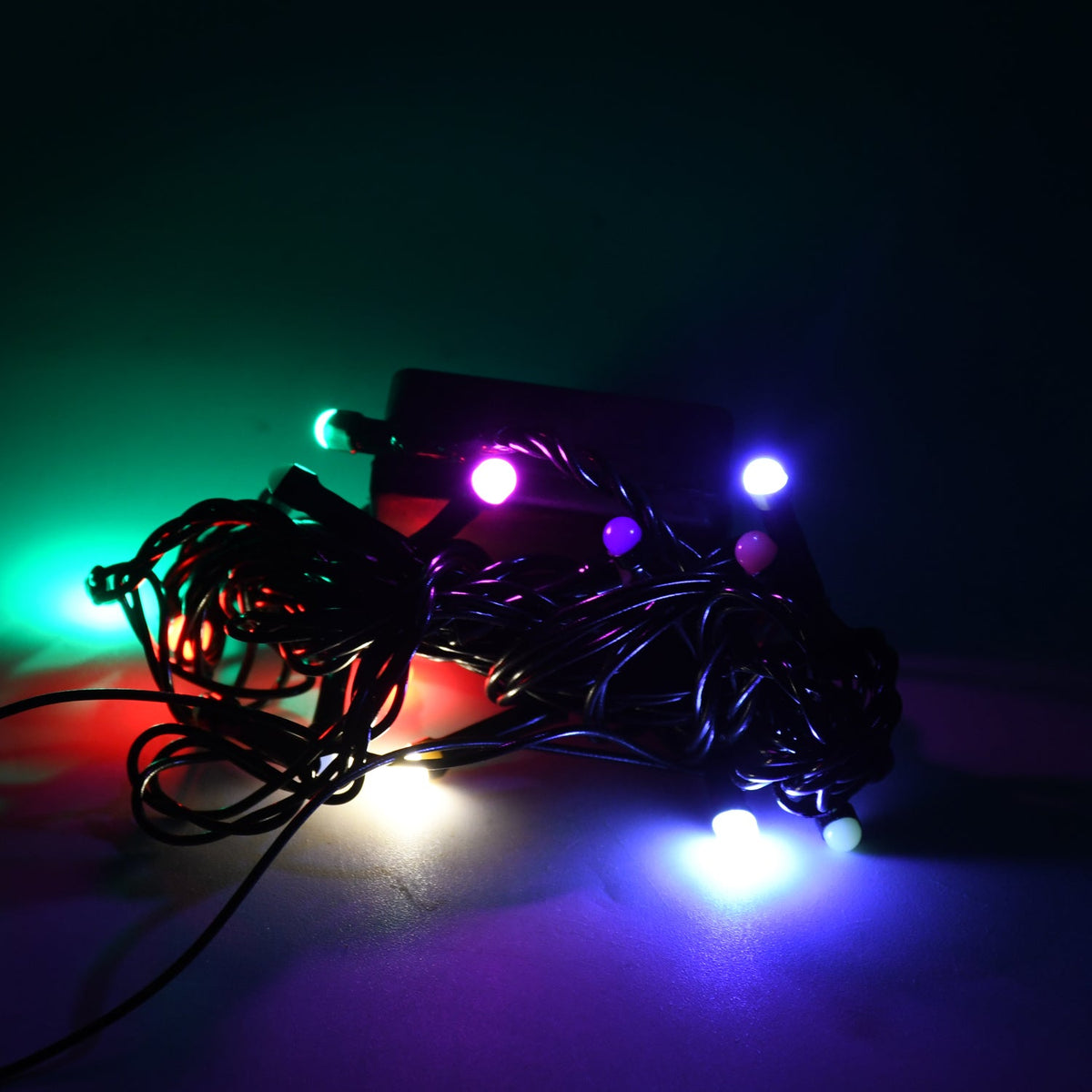 Vibrant multi-color LED string lights illuminating a festive indoor setting.